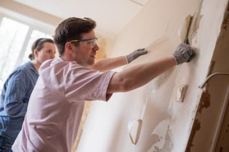 young-couple-removing-old-wallpaper-from-walls-pre-2024-10-18-04-39-07-utc (1).jpg
